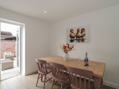 A dining room with a table and chairs at 3 The Stables Highbridge