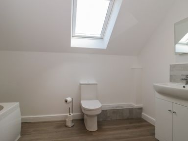 A bathroom with a toilet, sink, and bathtub at 3 The Stables Highbridge