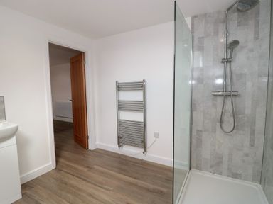A bathroom with a shower and sink at 3 The Stables Highbridge
