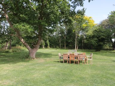 An outdoor area with a dining table and chairs at 3 The Stables Highbridge