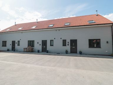 A building with multiple doors and windows at 3 The Stables Highbridge