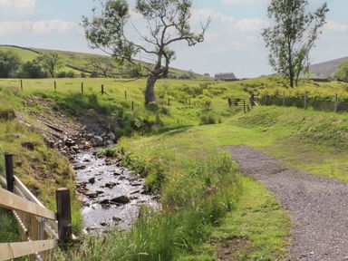 A rural landscape with a stream and trees at Barley near Nelson