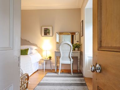 A bedroom with a bed and vanity at Bwthyn Morse in Llanfair