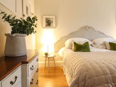 A bedroom with a bed and nightstand at Bwthyn Morse in Llanfair