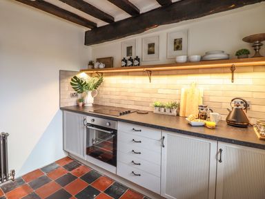 A kitchen with a countertop and oven at Bwthyn Canol in Llanfair