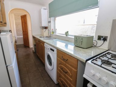 A kitchen with appliances and a window at Bolton Terrace in Workington
