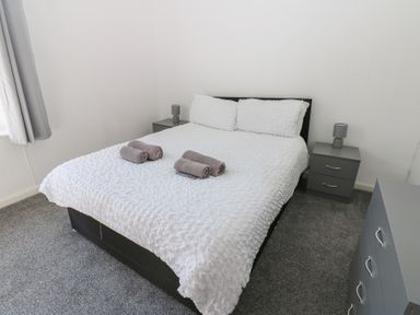 A bedroom with a bed and bedside tables at Bolton Terrace in Workington