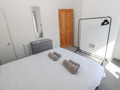 A bedroom with a bed and towels on it at Bolton Terrace in Workington