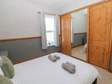A bedroom with a bed and towels on it at Bolton Terrace in Workington