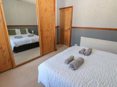 A bedroom with a bed and towels on it at Bolton Terrace in Workington
