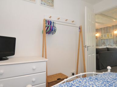 A bedroom with a dresser and hangers at 8 Hillside Bude