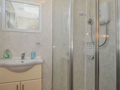 A bathroom with a sink and shower at 8 Hillside in Bude