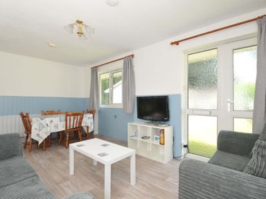 A living room with a table and chairs at 4 Rosecraddoc Lodge Holiday Bungalows Liskeard