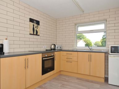 A kitchen with countertops, oven, and window at 4 Rosecraddoc Lodge Holiday Bungalows in Liskeard
