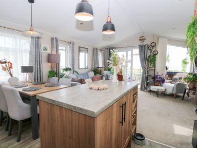 A living room and dining area with a table and chairs at No. 2 - Seaview in Kessingland