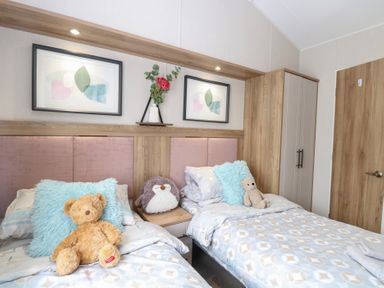 A bedroom with two beds and stuffed toys at No. 2 - Seaview, Kessingland