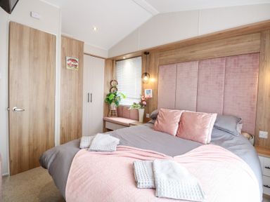 A bedroom with a bed and plant at No. 2 - Seaview in Kessingland