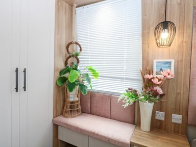 A seating area with a plant, light fixture, and flower arrangement at No. 2 - Seaview, Kessingland
