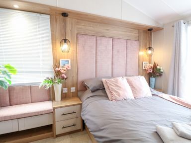A bedroom with a bed and shelf at No. 2 - Seaview in Kessingland