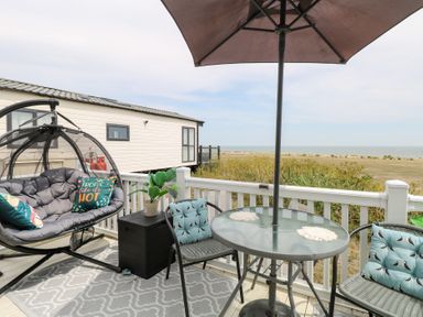 An outdoor seating area with a hanging chair and table at No. 2 - Seaview Kessingland
