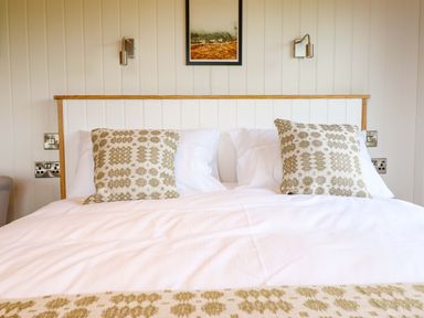 A bedroom with a bed and pillows at Defaid Cymreig in Oswestry