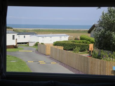 A view of caravans and sea from a property at Puffin Way Holiday Caravan