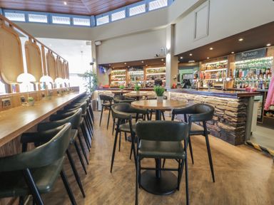 A bar area with tables and stools at Puffin Way Holiday Caravan