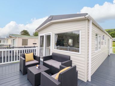 A deck with outdoor furniture at 8 Puffin Way in Llwyngwril