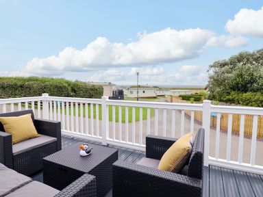 An outdoor area with seating and a view at 8 Puffin Way in Llwyngwril