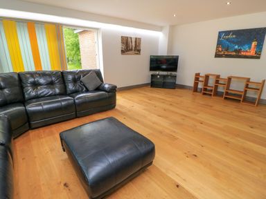 A living room with a sofa and television at Silver Copse in Frilford Heath Near Abingdon
