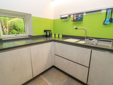A kitchen with a sink and kettle at Silver Copse Frilford Heath Near Abingdon