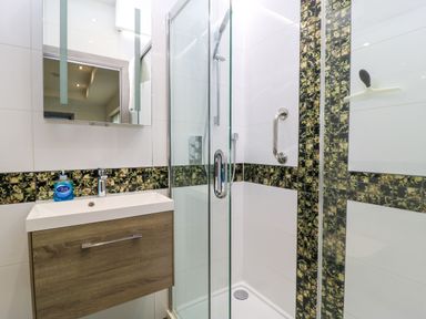 A bathroom with a shower and sink at Silver Copse Frilford Heath Near Abingdon