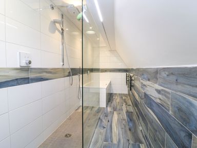 A bathroom with a shower and bath at Silver Copse in Frilford Heath Near Abingdon