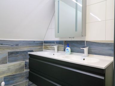 A bathroom with a double sink and mirror at Silver Copse Frilford Heath Near Abingdon