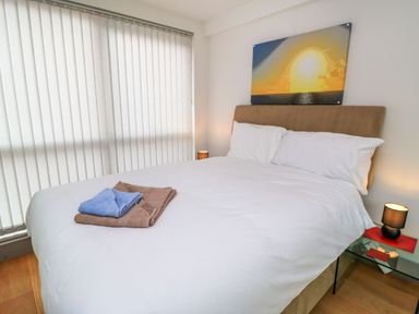 A bedroom with a bed and bedside table at Silver Copse Frilford Heath Near Abingdon