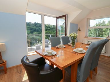 A dining room with a table and chairs at 1 Bryn Beudy Stepaside