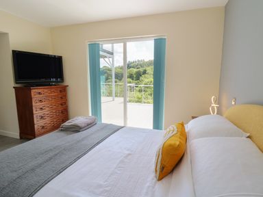A bedroom with a bed and television at 1 Bryn Beudy, Stepaside
