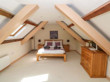 A bedroom with a bed and bedside tables at Carreg Las in Haverfordwest