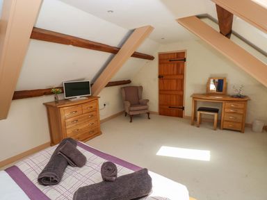 A bedroom with a bed and television at Carreg Las in Haverfordwest