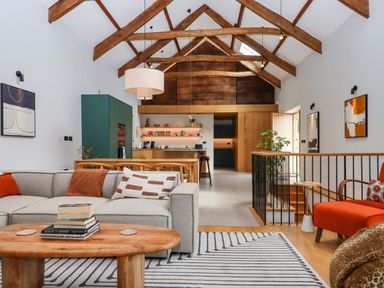 A living room with a sofa and coffee table at Lower Walreddon Barn in Tavistock