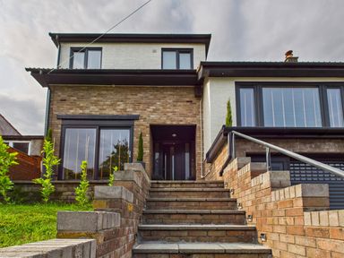 A house with stairs and plants at 59a Gwscwm Road