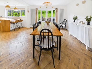 A dining room with a table and chairs at 59a Gwscwm Road