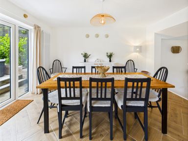 A dining room with a wooden table and chairs at 59a Gwscwm Road