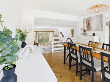 A dining room with a table and chairs at 59a Gwscwm Road