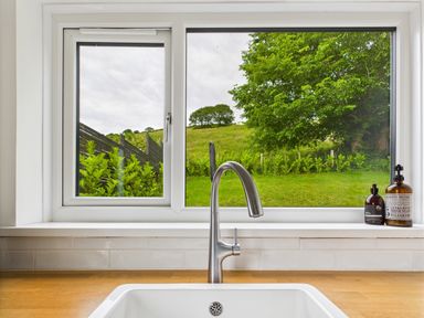 A window view with a sink and faucet at 59a Gwscwm Road