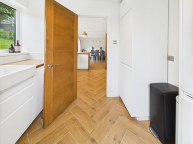 A kitchen with a sink and door at 59a Gwscwm Road