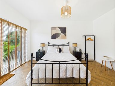 A bedroom with a bed and bedside table at 59a Gwscwm Road