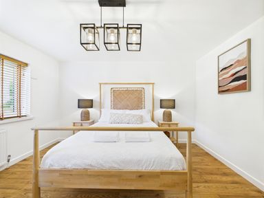 A bedroom with a bed and nightstand at 59a Gwscwm Road