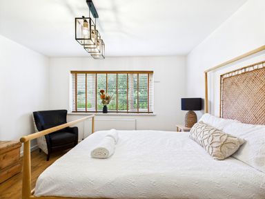 A bedroom with a bed, chair and window at 59a Gwscwm Road