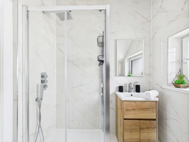 A bathroom with a shower and a vanity at 59a Gwscwm Road
